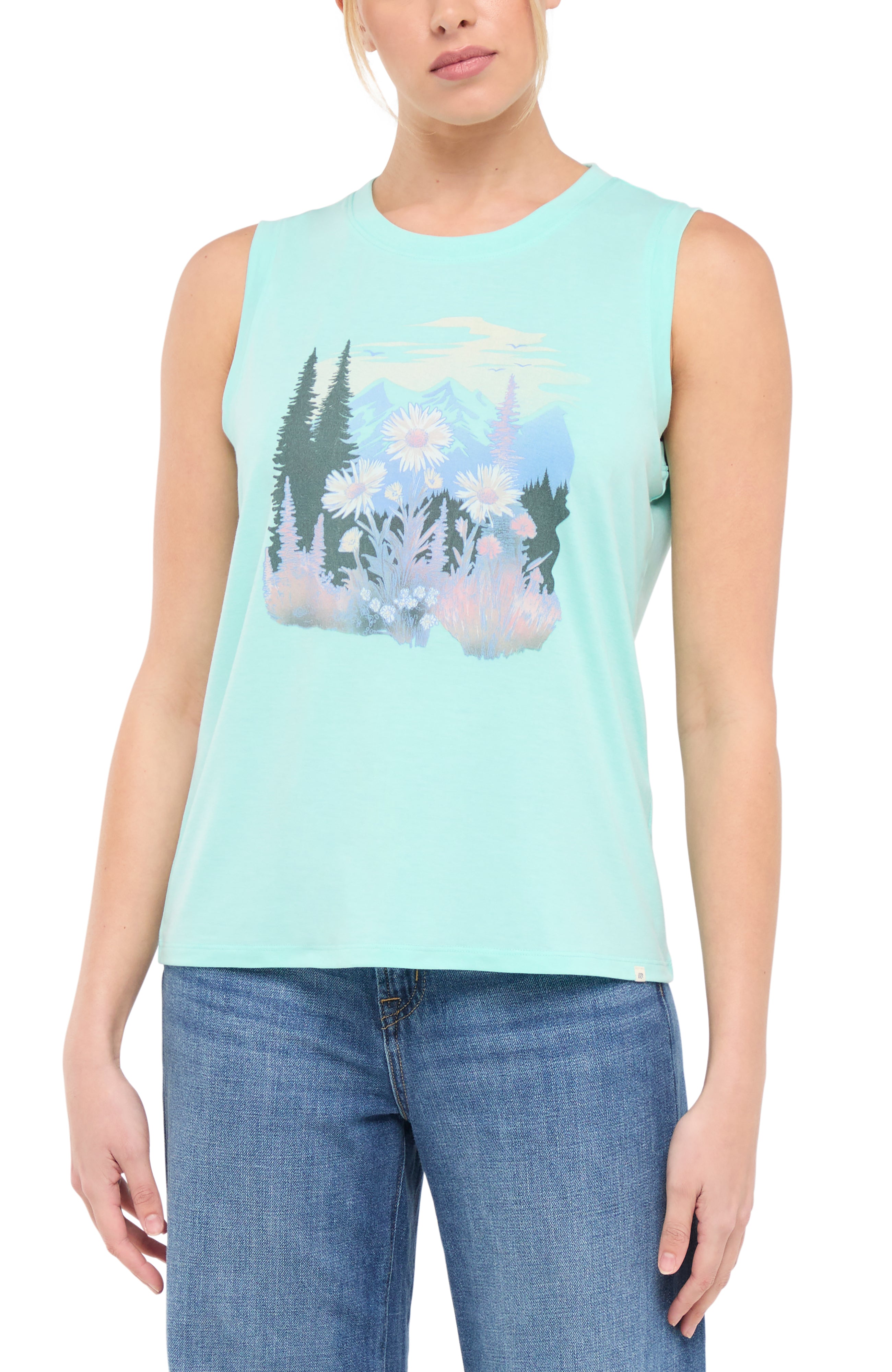 Front view of woman wearing a light teal blue sleeveless shirt with a trees and flowers nature graphic design on a white background.