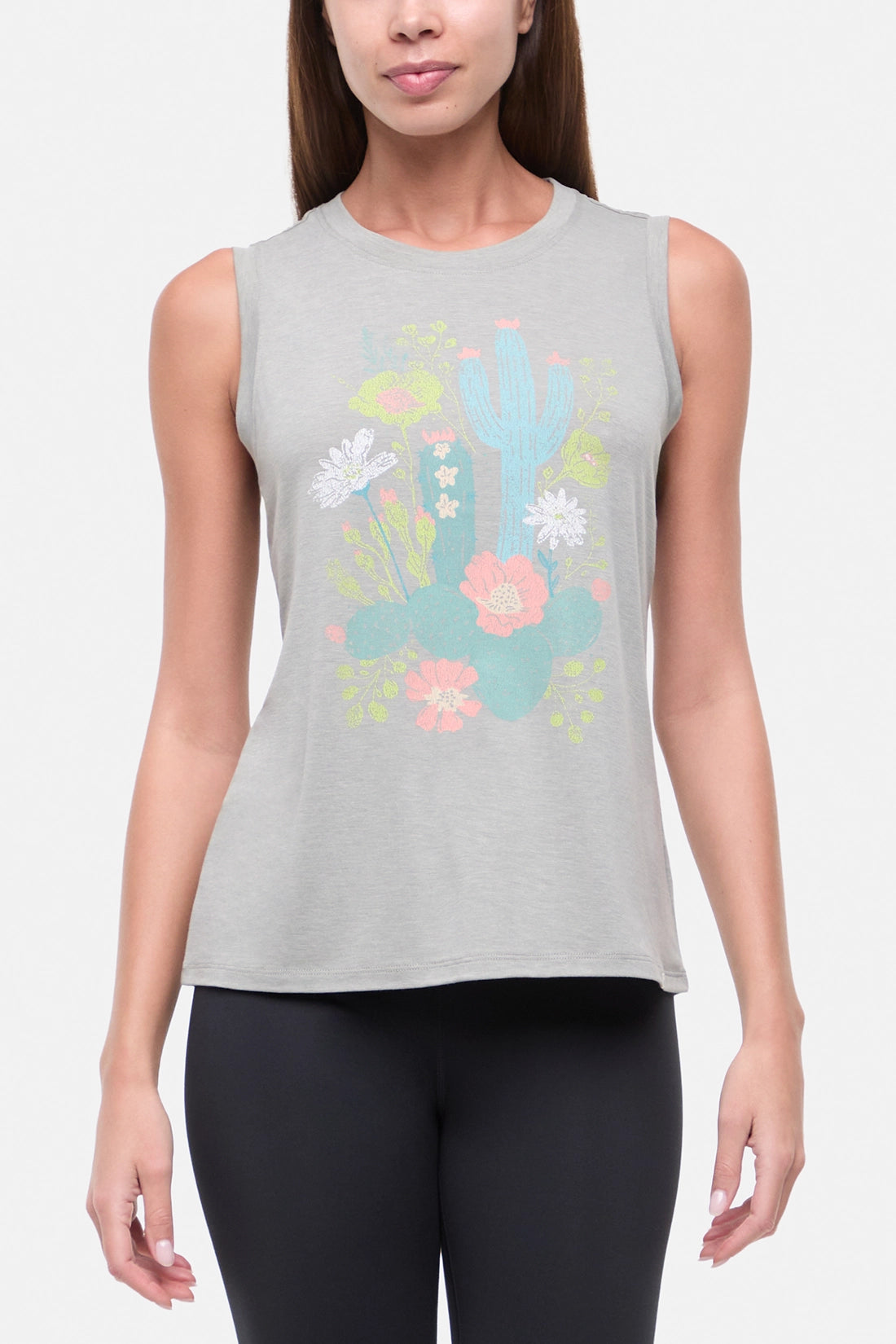 Front view of woman wearing a sleeveless gray top with colorful floral and cactus design on a white background.