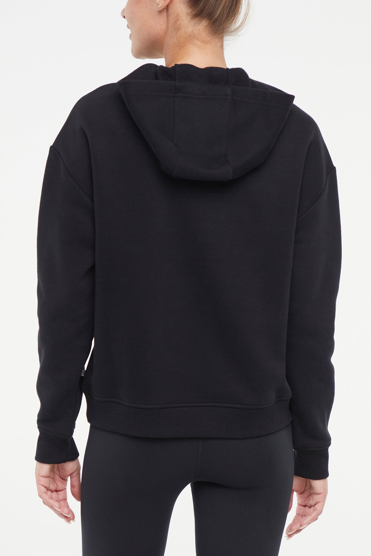 Camila Hoodie, side view showing pocket placement, showing visible design features and texture of the soft fleece fabric..
