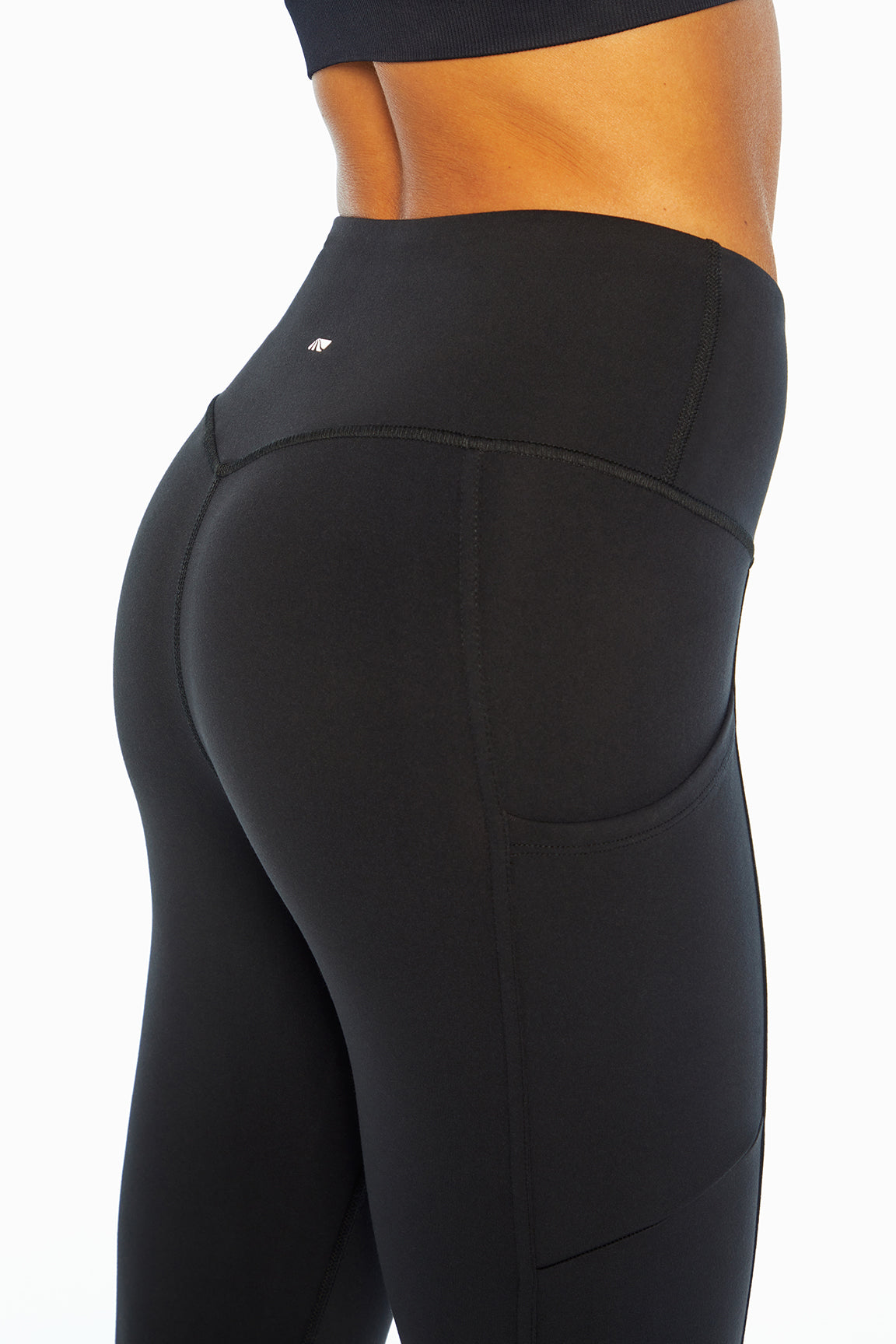 Eclipse Side Pocket Tummy Control Ankle Legging, back view, showing visible design features and texture of the stretch knit fabric..