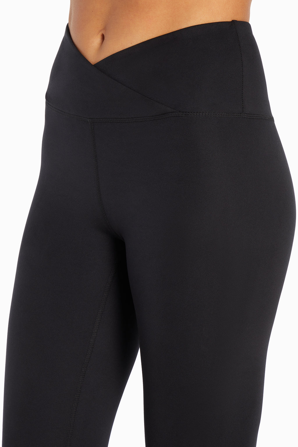 Balance Collection Crossover Legging, close-up view of fabric and stitching, showing visible design features and texture of the stretch knit fabric.. #color_black