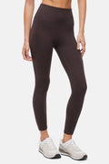 Front view of woman wearing dark brown leggings with a white background. #color_black-coffee