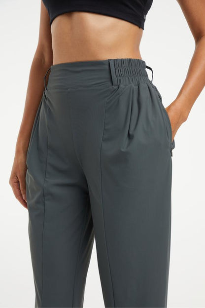 Nori Tapered Pant, close-up view of fabric and stitching, showing visible design features and texture of the durable stretch fabric.. 