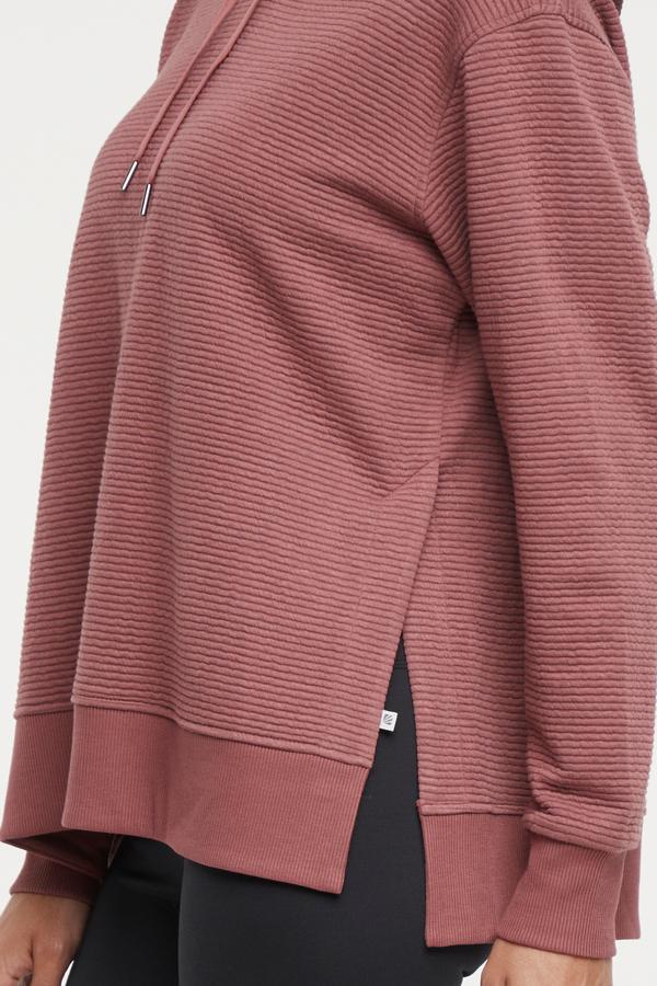 Cora Pullover Hoodie, back view, showing visible design features and texture of the soft fleece fabric.. 