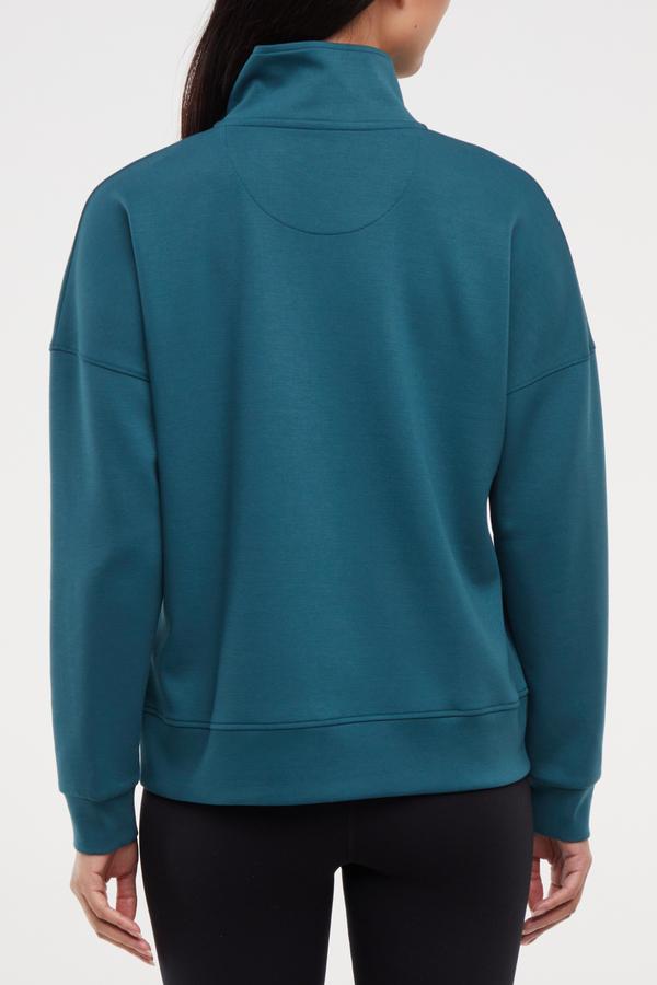 Sage 1/2 Zip, side view showing pocket placement, showing visible design features and texture of the soft knit fabric.. 