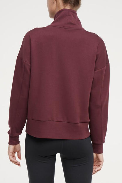 Sage Knit Pullover, side view showing pocket placement, showing visible design features and texture of the soft knit fabric.. 
