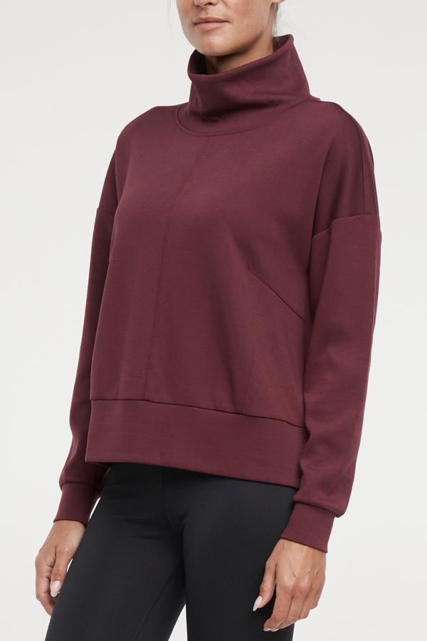 Sage Knit Pullover, close-up view of fabric and stitching, showing visible design features and texture of the soft knit fabric.. 