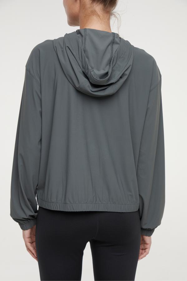 Nori Jacket, side view showing pocket placement, showing visible design features and texture of the smooth woven fabric.. 