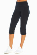 Zoey Tummy Control Capris, front view showing pocket placement, showing visible design features and texture of the soft knit fabric. #color_black