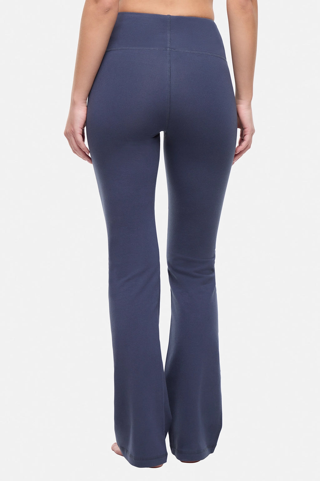 Back view of woman wearing navy blue yoga pants on a white background. #color_mood-indigo
