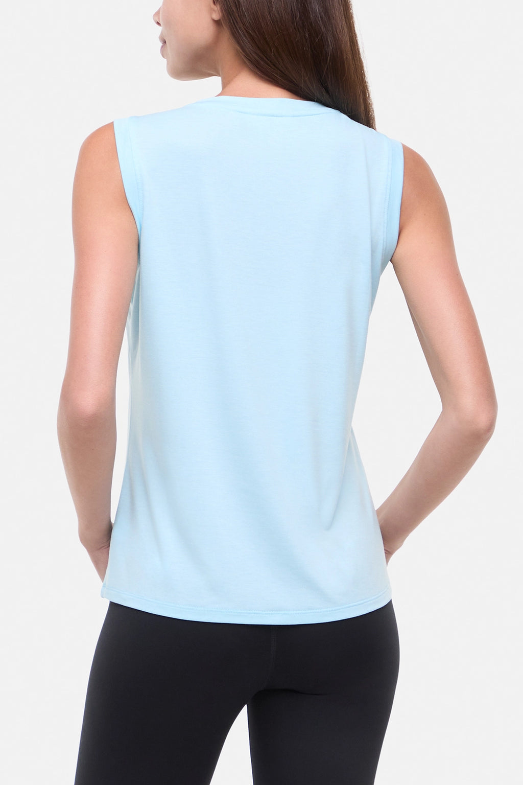 Back view of woman wearing a light blue sleeveless top on a plain background. #color_heather-ocean-current-butterfly-bunch