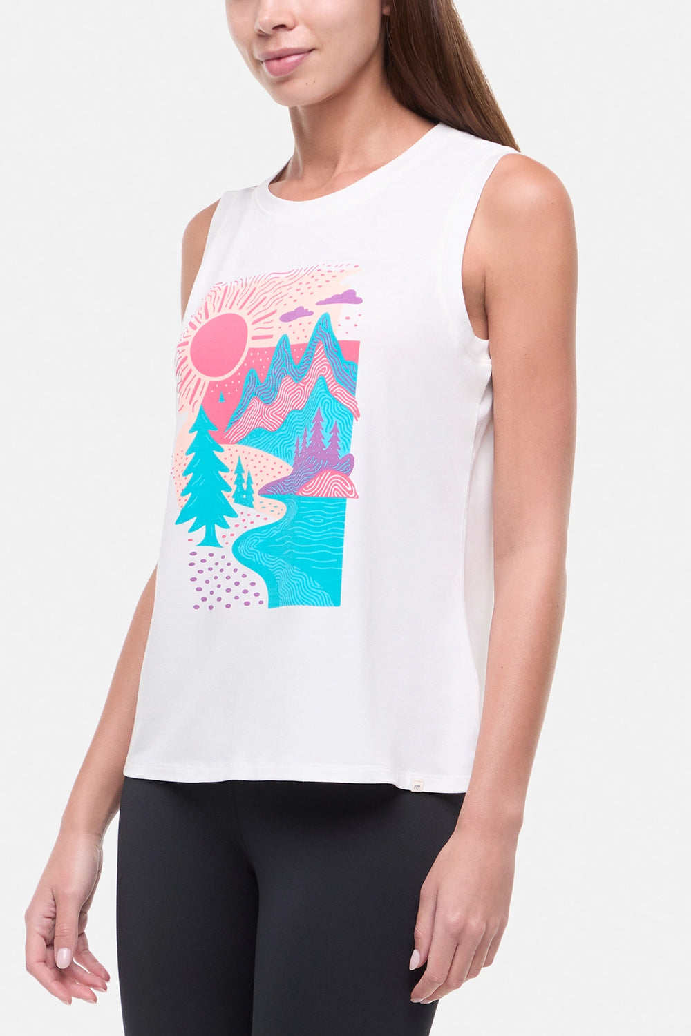 Side view of woman wearing white sleeveless shirt with a colorful nature graphic on a white background.