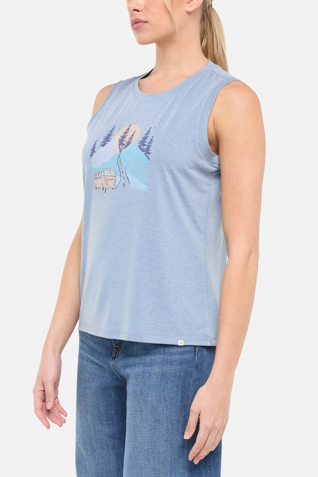 Side view of woman wearing a sleeveless light blue shirt with a graphic design of a van and mountains on white background. #color_heather-troposphere-road-trip-van