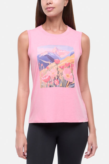 Front view of woman wearing a pink sleeveless top with a colorful floral and mountain design on a white background.