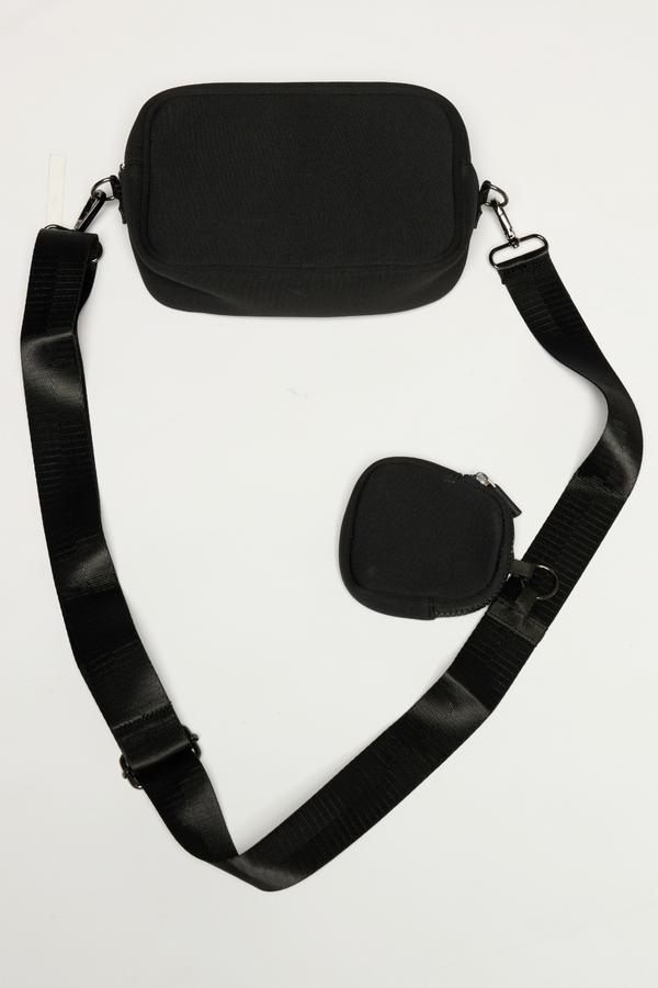 Joyce Sling Bag, side view showing pocket placement, showing visible design features and texture of the soft knit fabric.