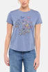 Front view of woman wearing a blue t-shirt with butterflies and floral design on a white background. 