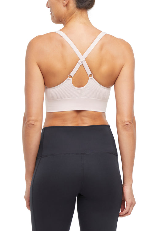 Addie Seamless Sports Bra, close-up view of fabric and stitching, showing visible design features and texture of the soft knit fabric.. #color_hushed-violet