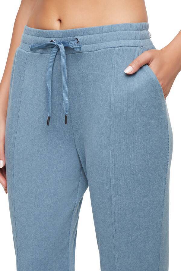 Riley Jogger, close-up view of fabric and stitching, showing visible design features and texture of the soft knit fabric.. 