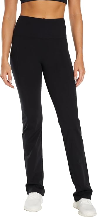 Front view of woman wearing black high-waisted pants on a white background. 