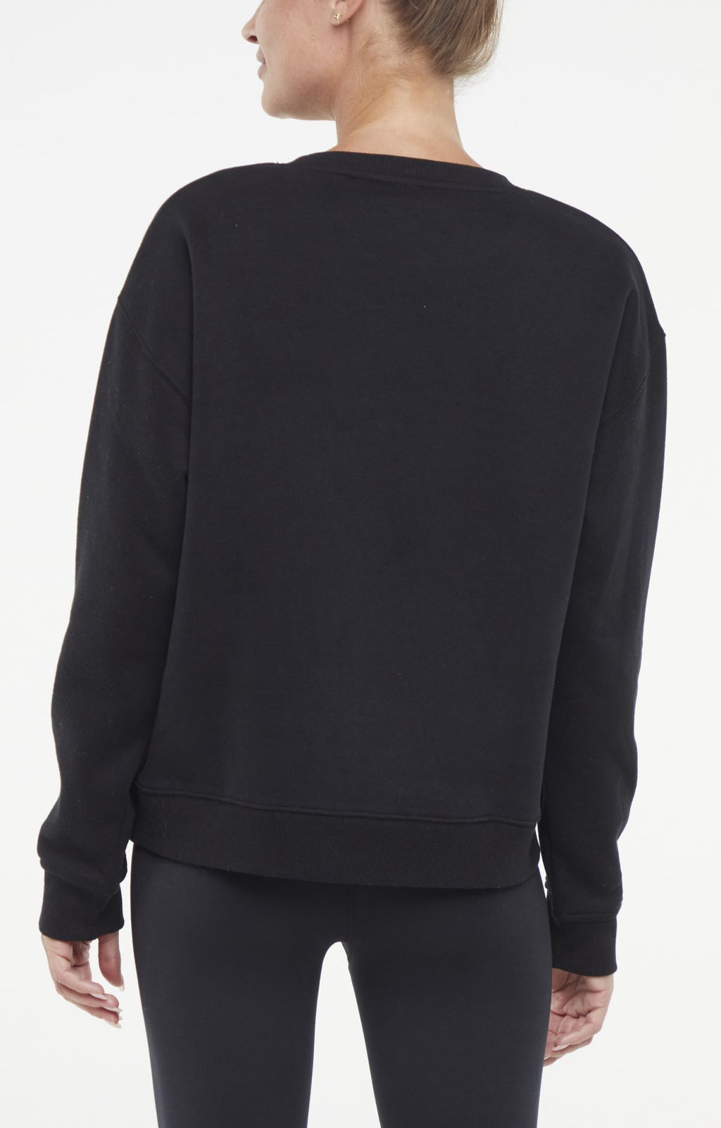 Camila Pullover, side view showing pocket placement, showing visible design features and texture of the soft knit fabric.. #color_black