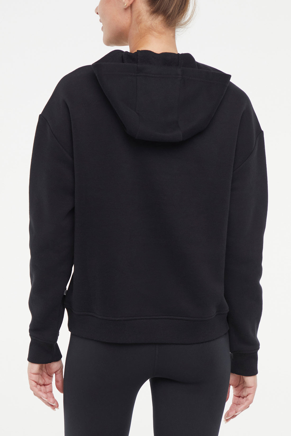 Camila Hoodie, side view showing pocket placement, showing visible design features and texture of the soft fleece fabric.. 