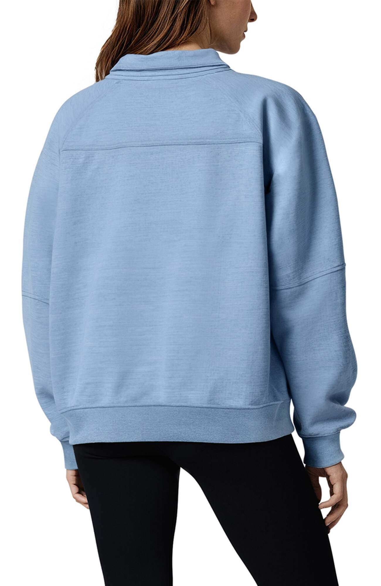 Camila 1/4 Zip Jacket, side view showing pocket placement, showing visible design features and texture of the smooth woven fabric.. 