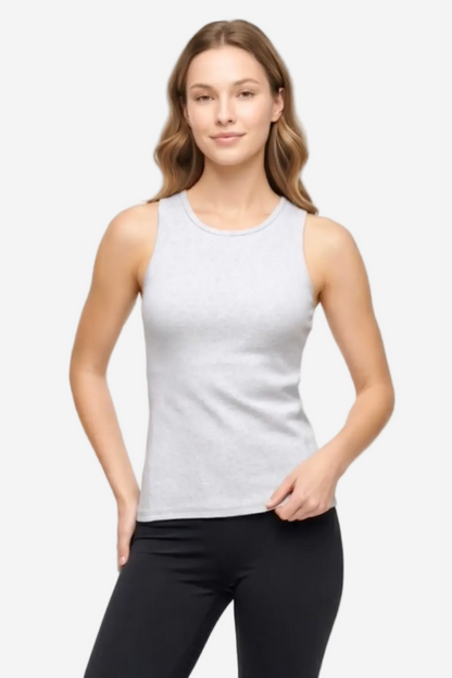A woman modeling a light gray sleeveless tank top with black leggings against a plain white studio background. 