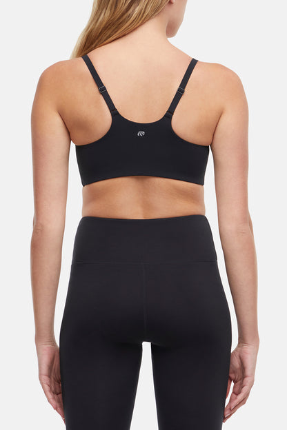 Alba Sports Bra, side view showing pocket placement, showing visible design features and texture of the soft knit fabric.