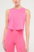 Front view of woman wearing a bright pink sleeveless top and pants on a light gray background. #color_pink-flambe