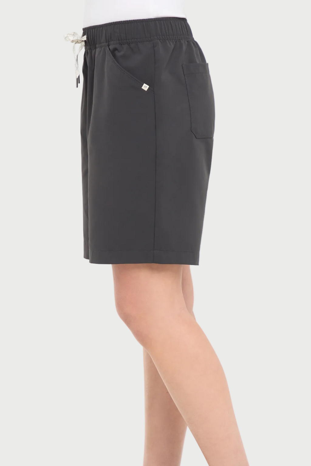 Side view of woman wearing dark gray shorts with a white drawstring, standing on a white background. #color_phantom