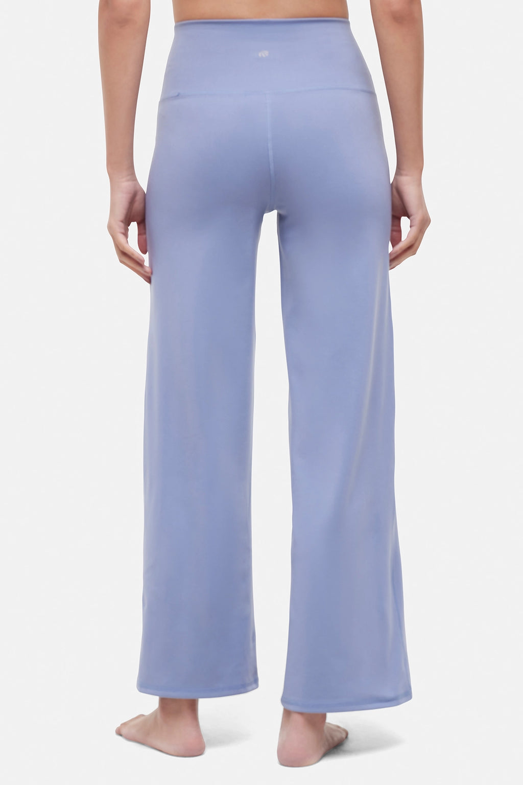 Back view of woman wearing light blue pants on a white background. #color_troposphere