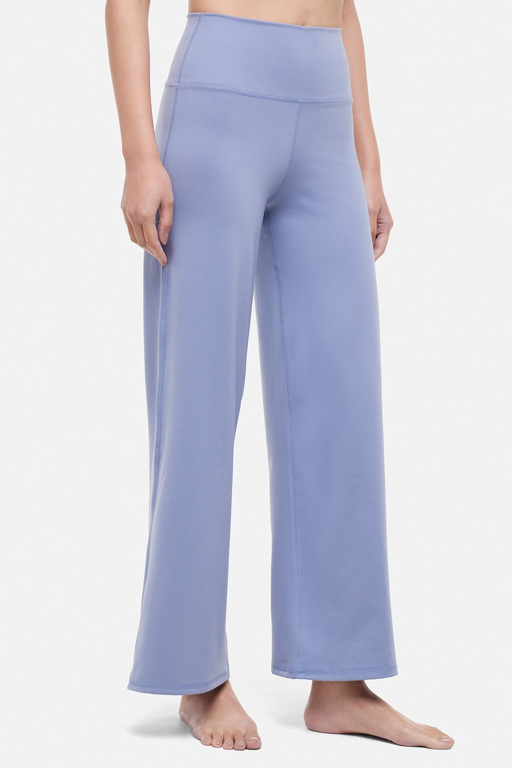 Front view of woman wearing light blue pants on a white background. #color_troposphere