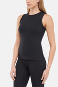 Quarter front view of woman wearing a black ribbed-knit sleeveless tank top and black leggings on a light gray background. #color_black