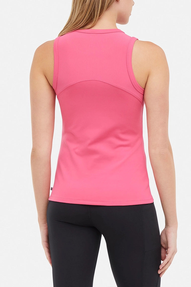 Back view of woman wearing a bright pink ribbed-knit sleeveless tank top and black leggings on a light gray background.