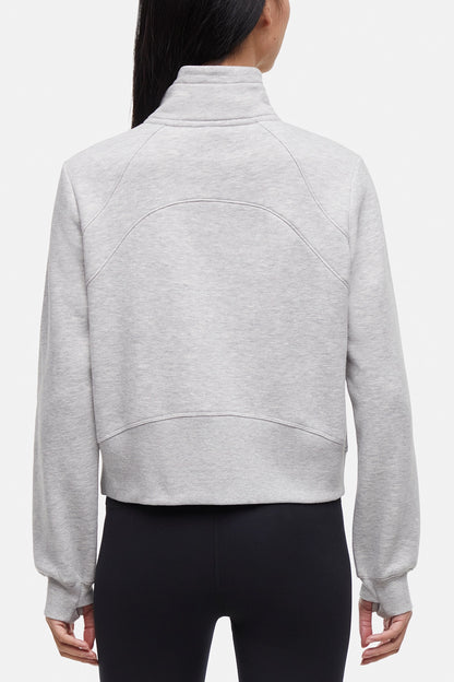 Back view of woman wearing heather gray half-zip pullover with thumbholes  on a white background. 