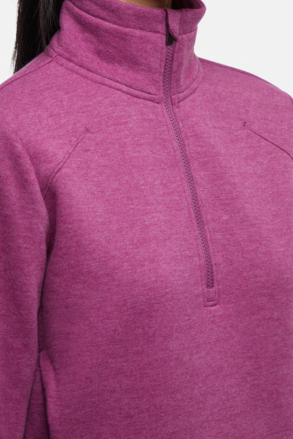 Close-up front view of woman wearing burgundy half-zip pullover with thumbholes on a white background. 