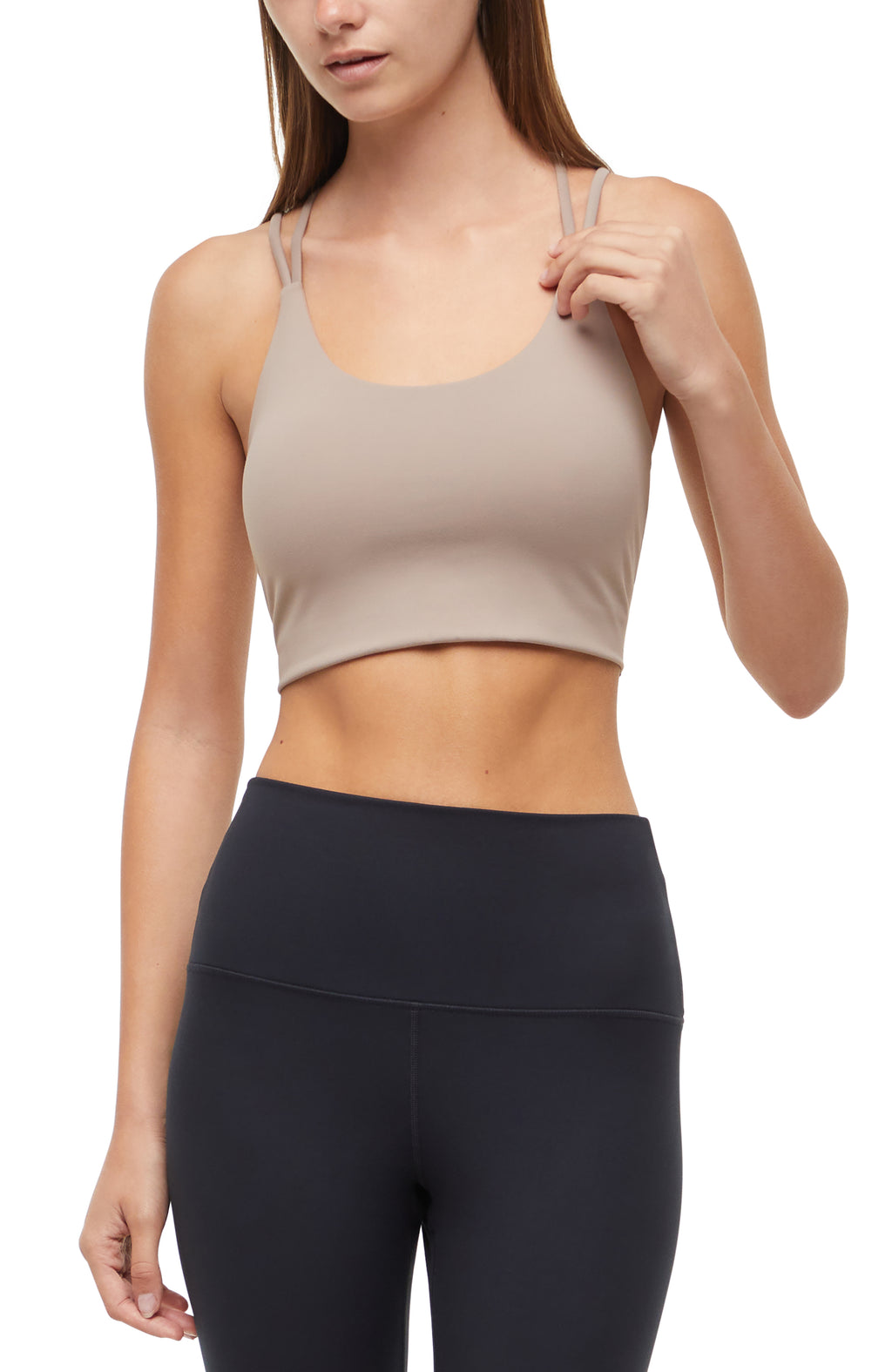 Front view of woman wearing a beige sports bra and black leggings on a white background. #color_taupe-gray