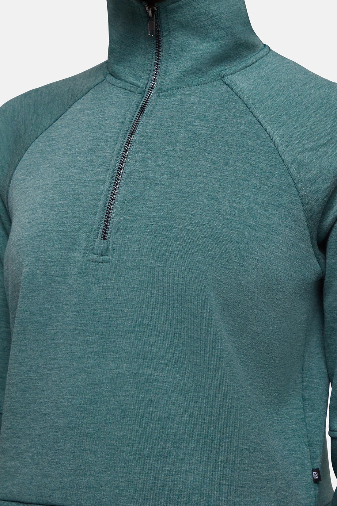 Close-up of a heathered teal green quarter-zip pullover sweatshirt with raglan sleeves and a high mock neck collar, shown on a model against a light gray background. 