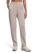 A person wearing light beige tapered-leg cropped pants with a wide elastic waistband and side pockets, paired with light beige sneakers, shown against a plain white studio background. #color_heather-atmosphere
