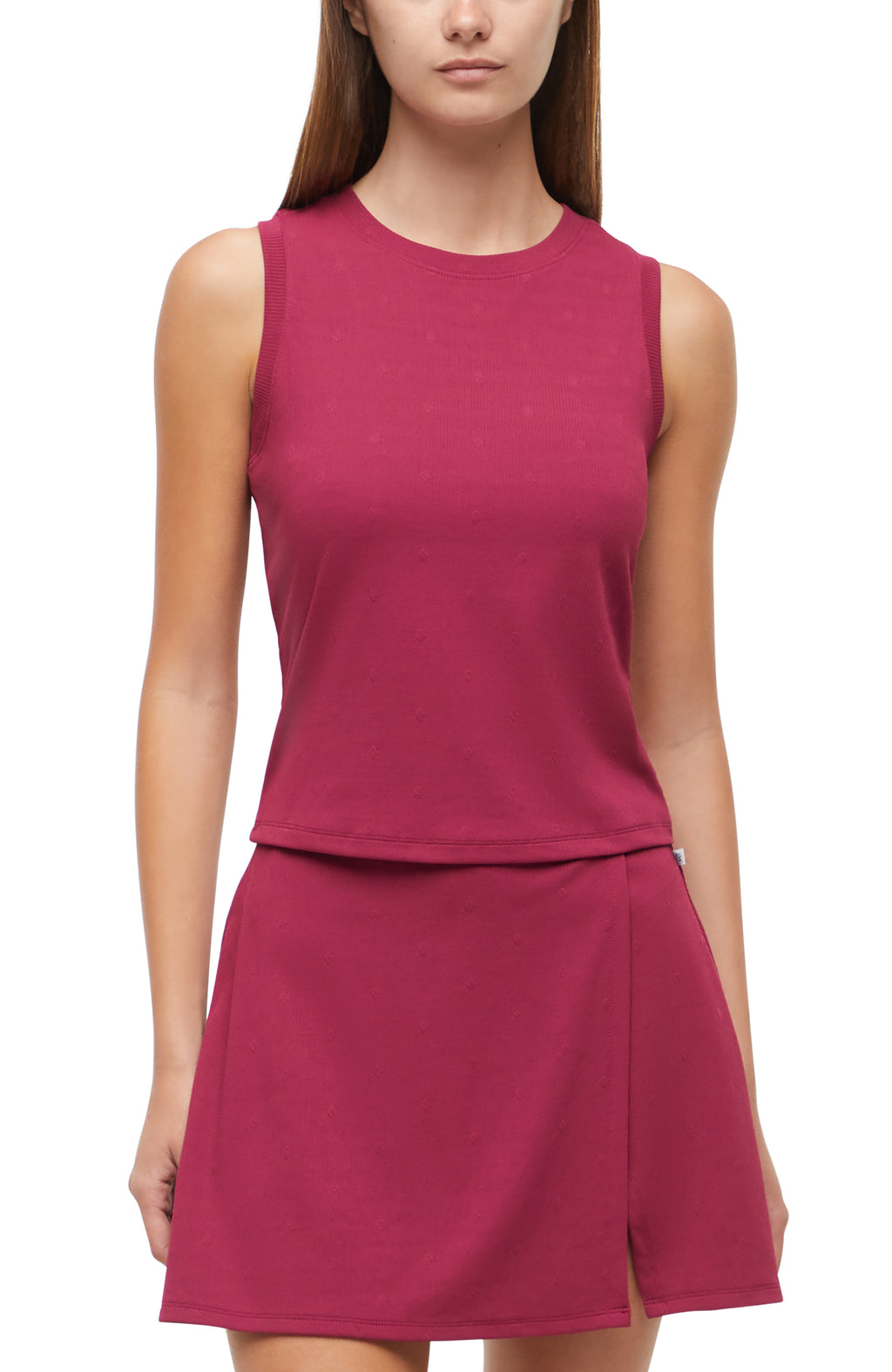 Front view of woman wearing a magenta sleeveless top and skirt set on a white background. #color_beaujolais