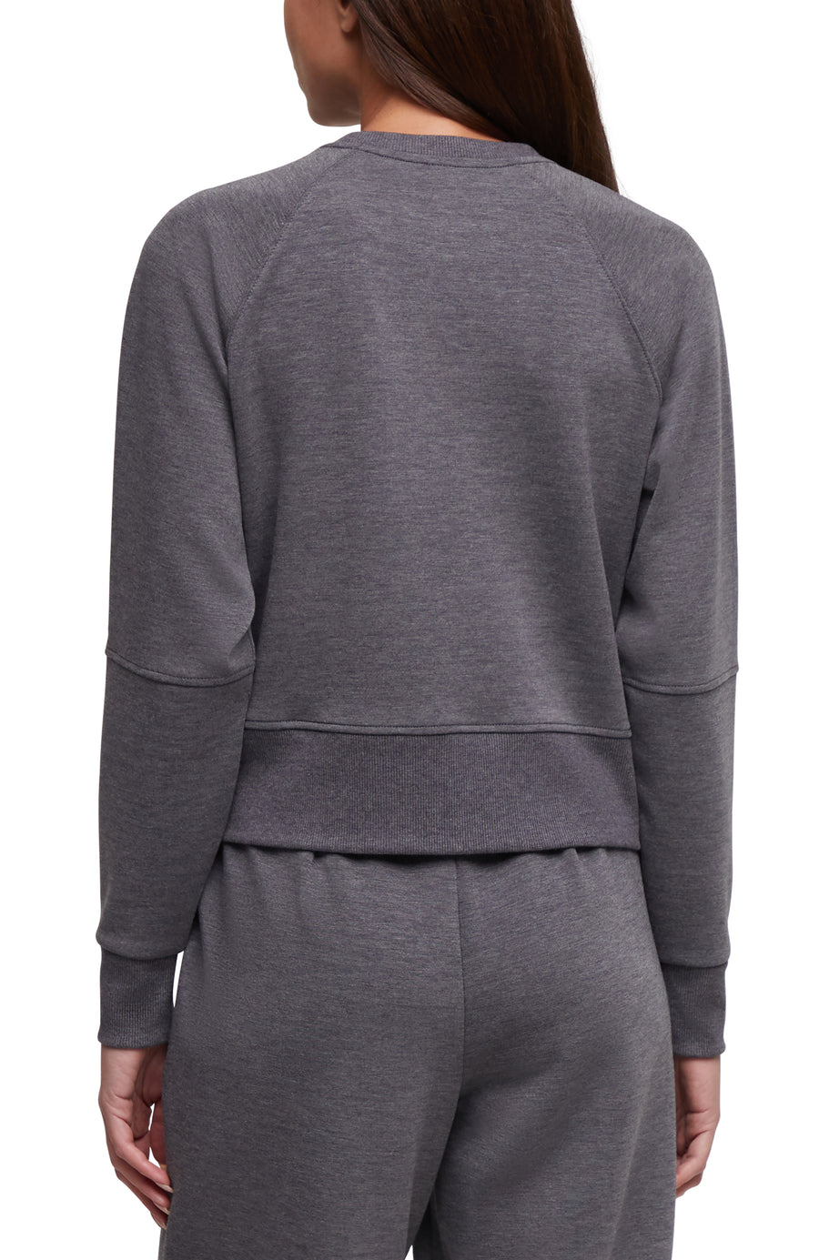 A woman shown from the back wearing a dark heather gray long-sleeve cropped sweatshirt and matching sweatpants against a plain white background. #color_heather-black