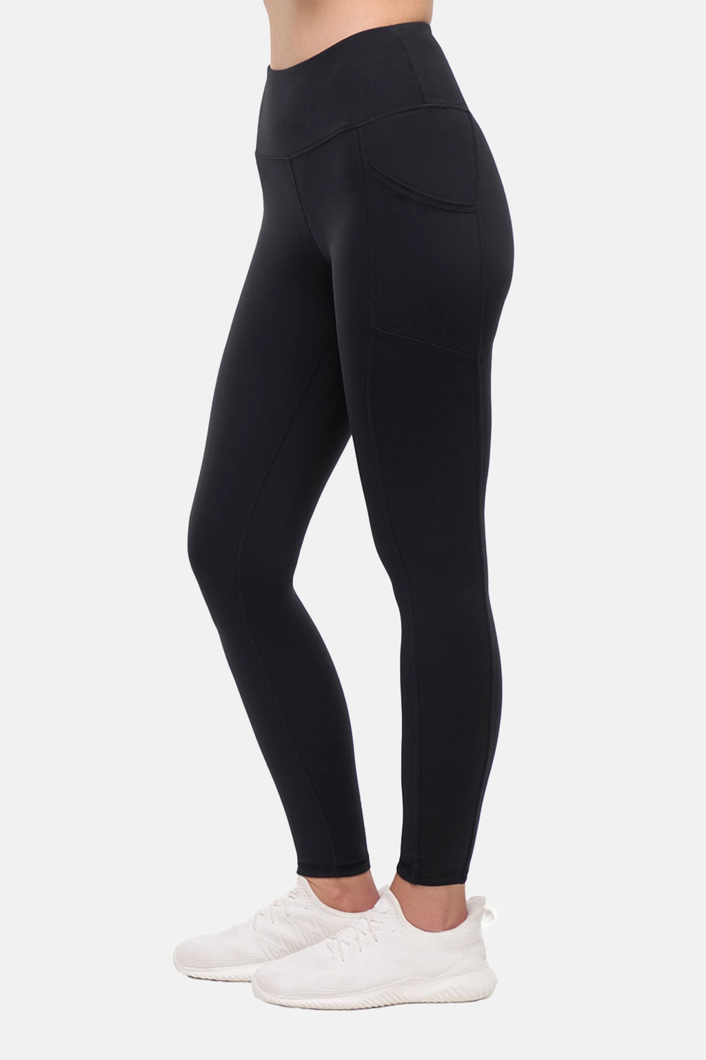 Side view of woman wearing black leggings on a white background. #color_black