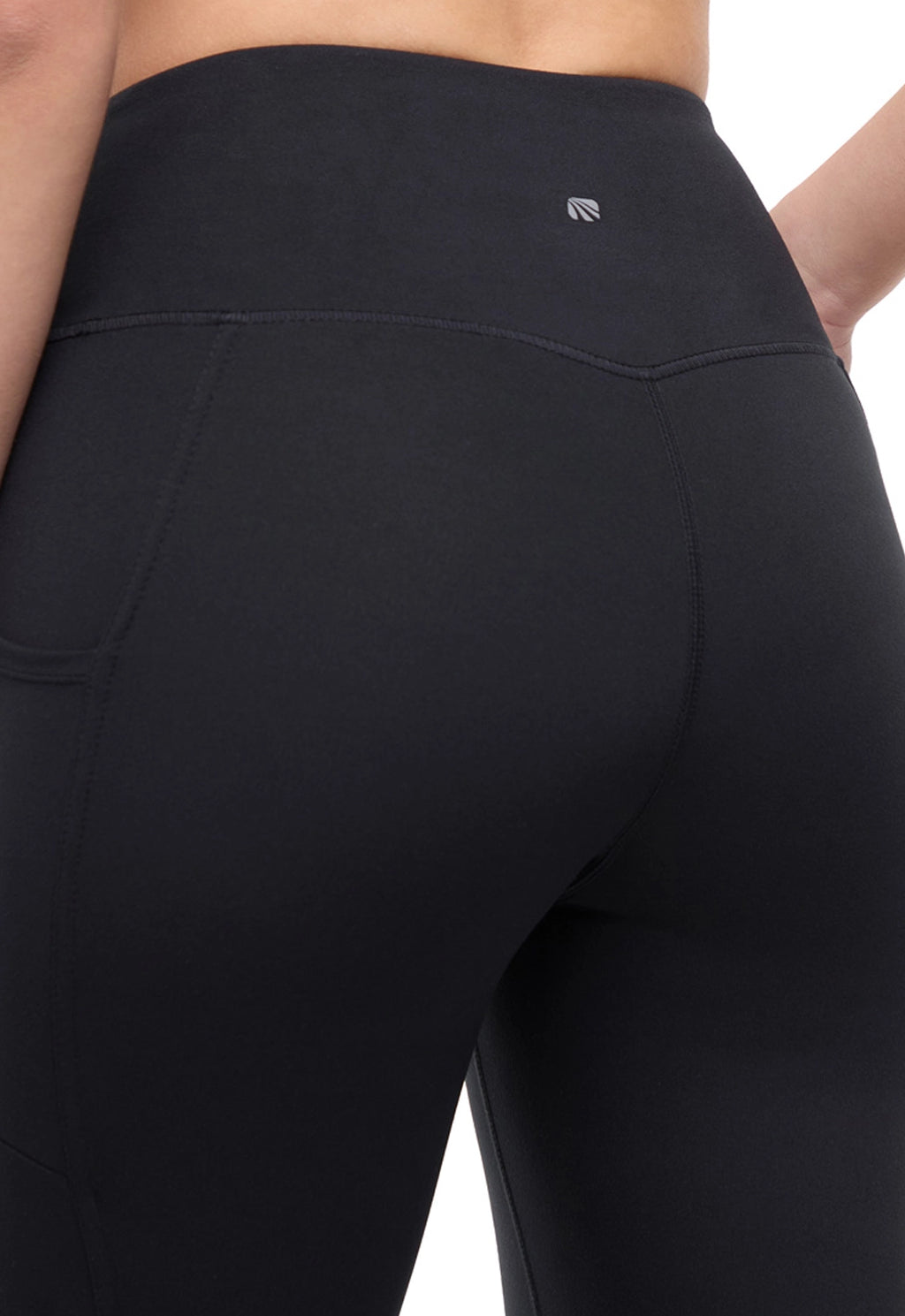 Close up back view of woman wearing black leggings on a white background. #color_black