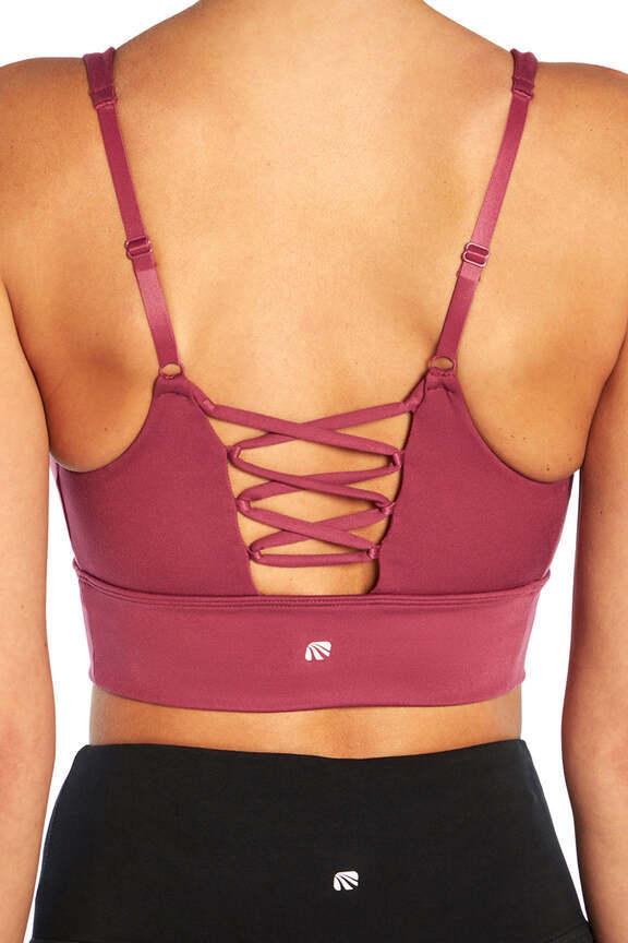 Alysha Sports Bra, side view showing pocket placement, showing visible design features and texture of the soft knit fabric.. 