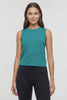 Video view of woman wearing a teal sleeveless top and black leggings on a white background. #color_quetzal-green