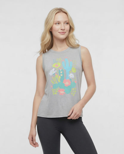 Video  view of woman wearing a sleeveless gray top with colorful floral and cactus design on a white background. 