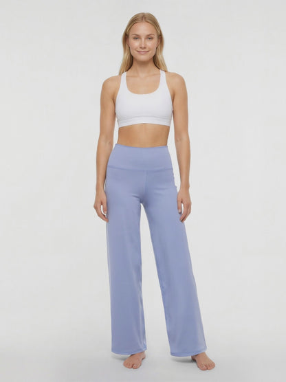 Video view of woman wearing light blue pants on a white background. 