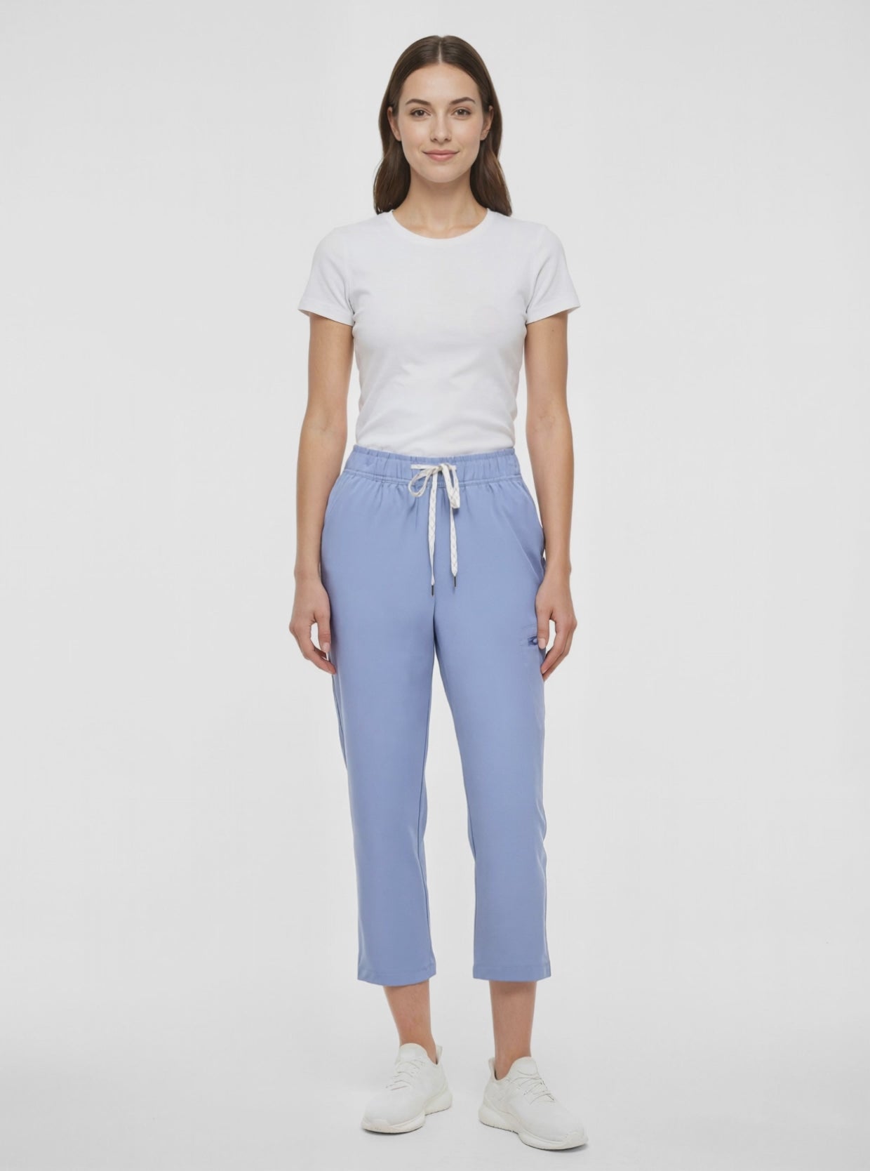 Video view of light blue pants worn by a woman with white drawstring waist on a white background. 