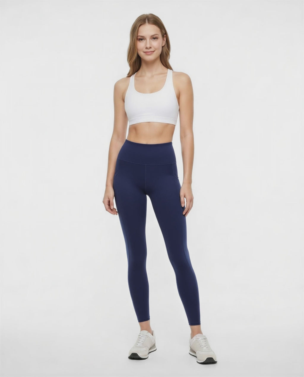 Video view of woman wearing navy leggings with a white background. #color_peacoat
