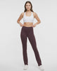 Video view of woman wearing brown yoga pants with a plain background. #color_black-coffee